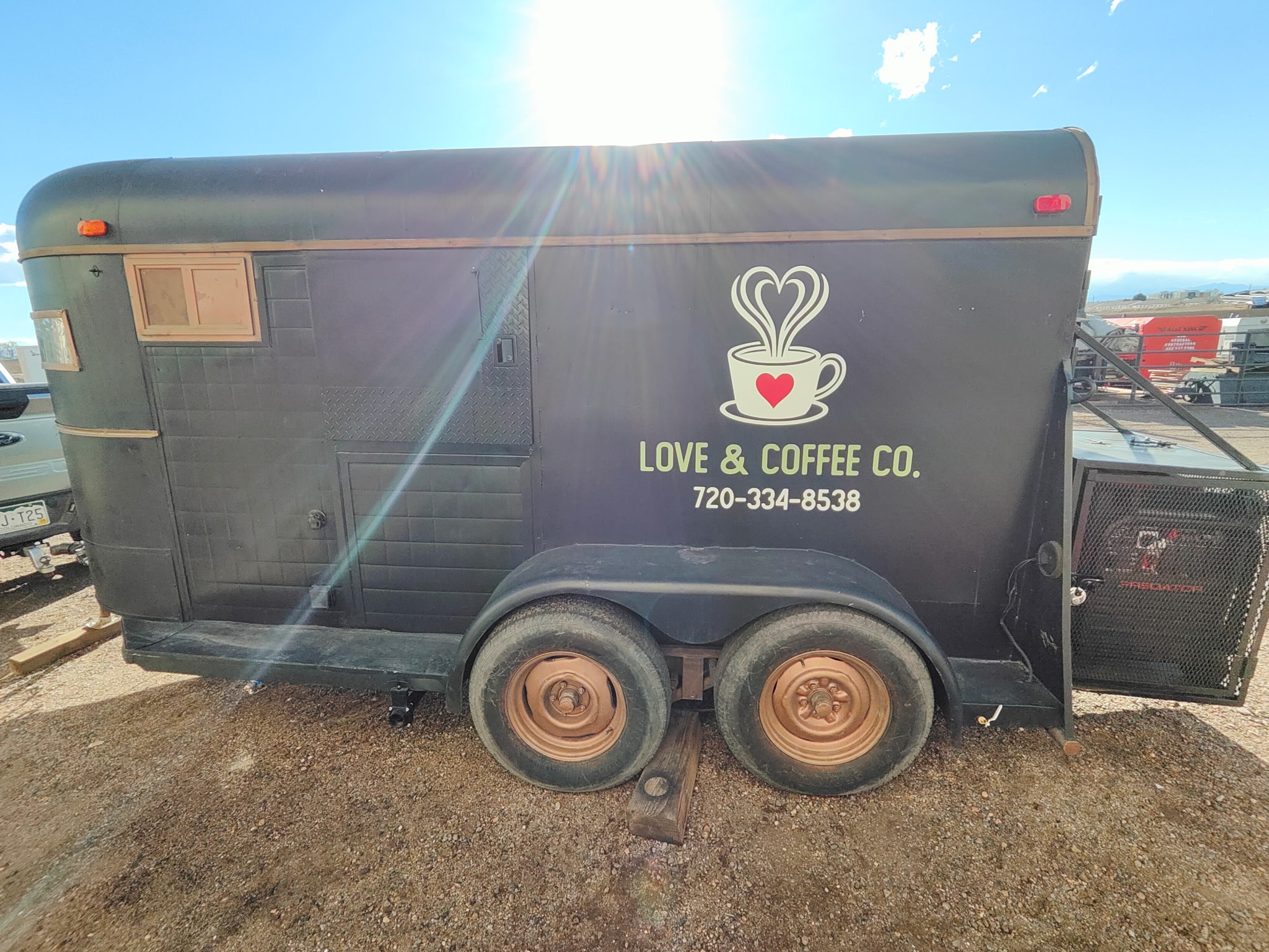 The Love & Coffee Co. mobile coffee trailer parked outdoors in the Colorado sunshine